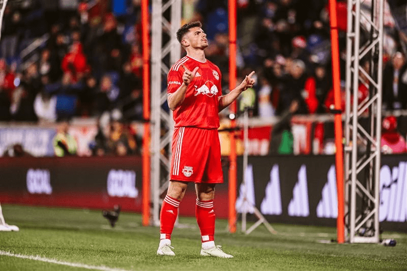 New York Red Bulls player Dante Vanzier celebrates on the field, after scoring a spectacular goal.