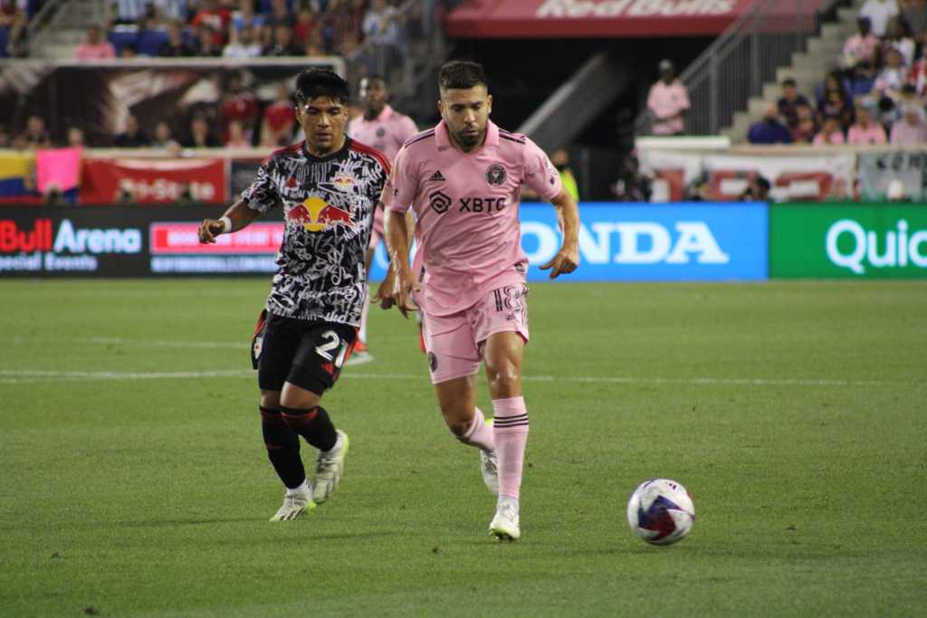 Jordi Alba of Inter Miami gets past New York Red Bulls midfielder Omir Fernandez. 