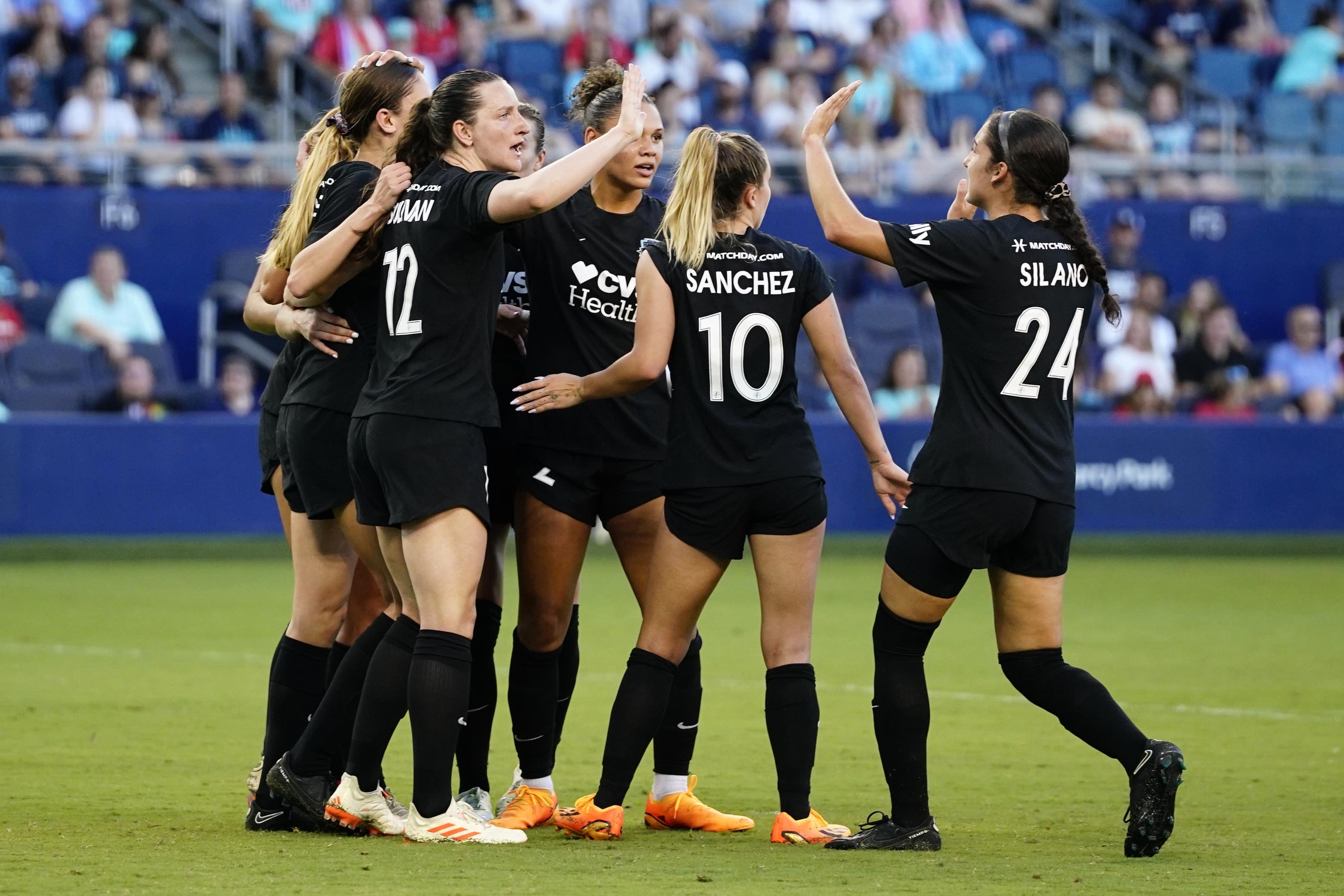 Jun 18, 2023; Kansas City, Kansas, USA; Washington Spirit midfielder Andi Sullivan (12) and Washington Spirit midfielder Ashley Sanchez (10) and teammates celebrate after scoring a goal during the second half at Children's Mercy Park. Mandatory Credit: Jay Biggerstaff-USA TODAY Sports