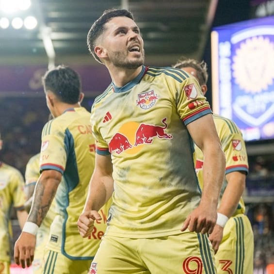Lewis Morgan celebrates a goal for New York Red Bulls wearing the team's yellow away kit at Red Bull Arena