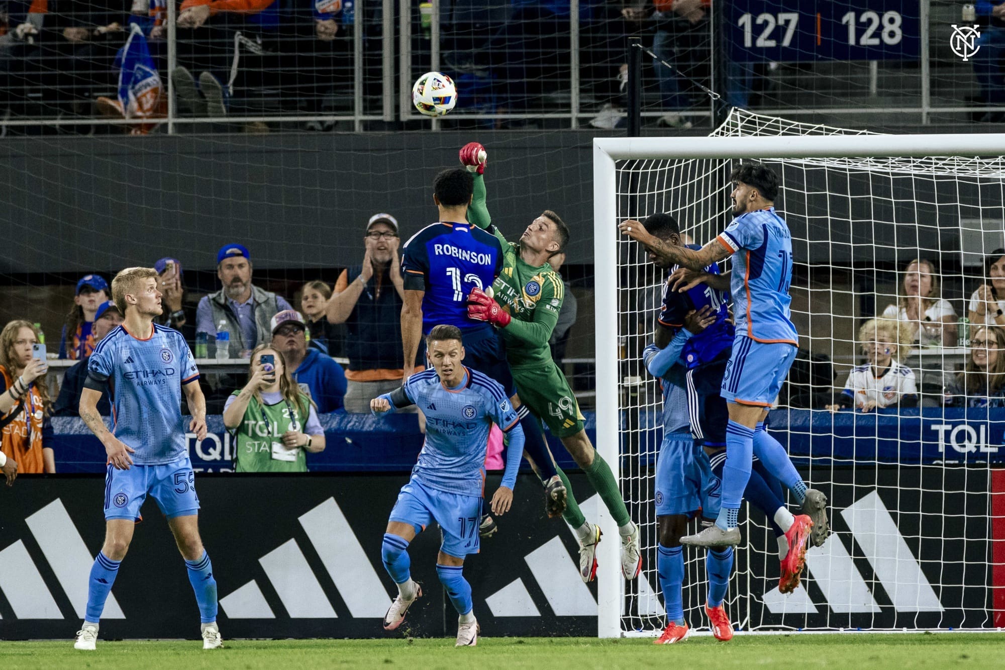 New York City FC goalkeeper Matt Freese leaps and punches out a dangerous cross during an intense match against FC Cincinnati at TQL Stadium