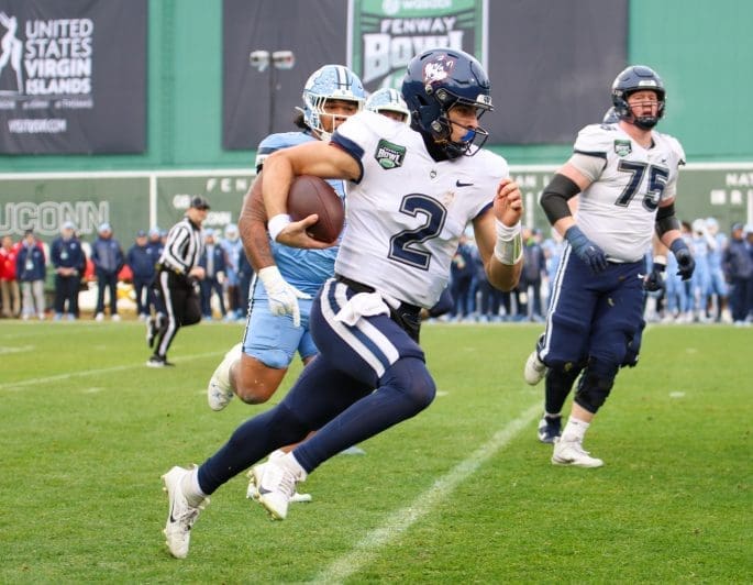 12/28/24 Boston MA, Fenway Park| UConn QB Joe Fagnano rushing for first down. Mandatory Credit: Bad Dawg Sports/ Jose Pichirilo