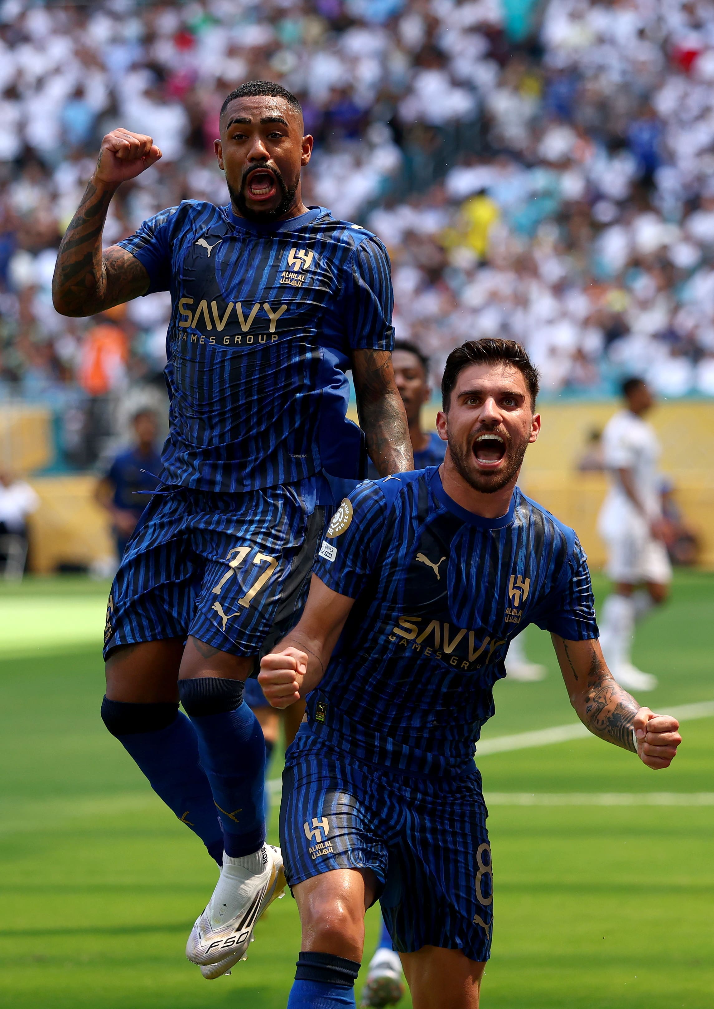 MIAMI GARDENS, FLORIDA - JUNE 18: Ruben Neves #8 of Al Hilal celebrates with teammate Malcom #77 scoring his team's first goal via penalty during the FIFA Club World Cup 2025 group H match between Real Madrid CF and Al Hilal at Hard Rock Stadium on June 18, 2025 in Miami Gardens, Florida. (Photo by Rich Storry - FIFA/FIFA via Getty Images)