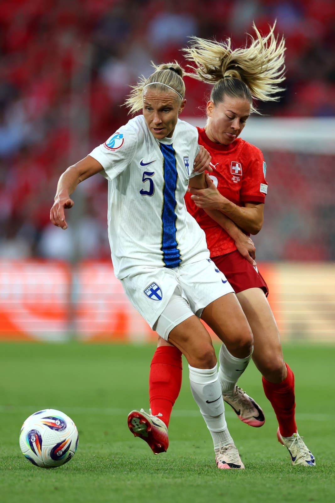 GENEVA, SWITZERLAND - JULY 10: Emma Koivisto of Finland battles for possession with Nadine Riesen of Switzerland during the UEFA Women's EURO 2025 Group A match between Finland and Switzerland at Stade de Geneve on July 10, 2025 in Geneva, Switzerland. (Photo by Molly Darlington - UEFA/UEFA via Getty Images)