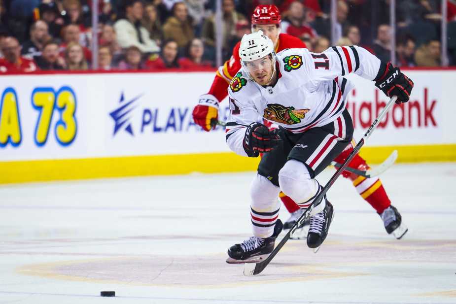 Apr 4, 2023; Calgary, Alberta, CAN; Chicago Blackhawks right wing Taylor Raddysh (11) skates against the Calgary Flames during the third period at Scotiabank Saddledome. 