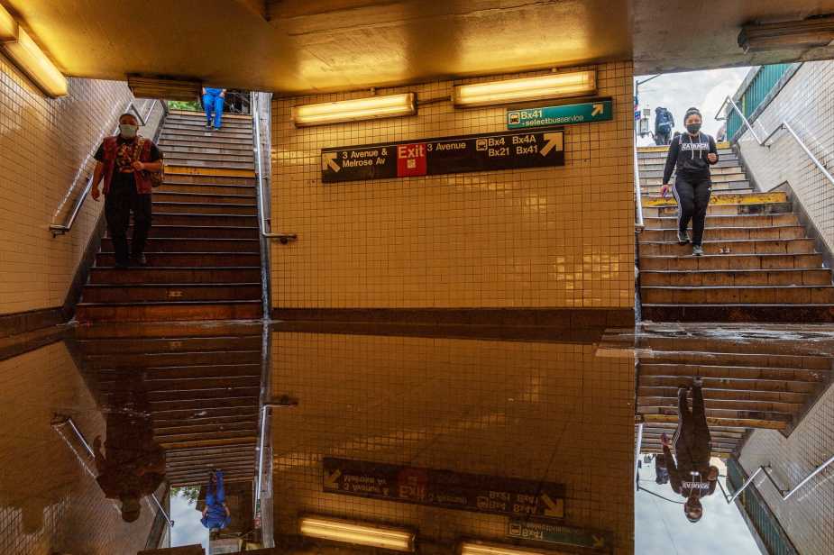 NEW YORK, NY - SEPTEMBER 02: Commuters walk into a flooded 3rd Avenue / 149th st subway station and disrupted service due to extremely heavy rainfall from the remnants of Hurricane Ida on September 2, 2021, in New York City. Multiple fatalities have been reported in the region as the storm passed through New York City, dumping 3.15 inches of rain in the span of an hour in Central Park and causing massive flooding in Brooklyn. (Photo by David Dee Delgado/Getty Images)