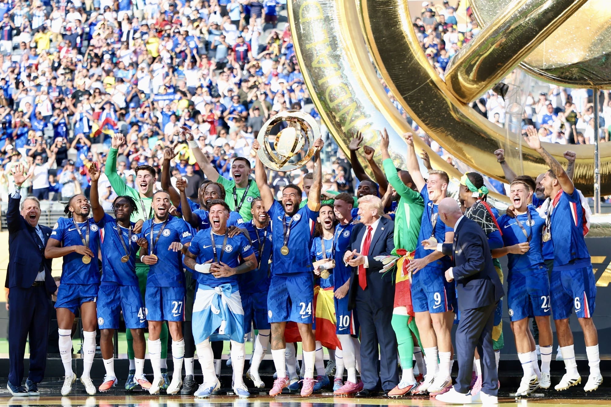 7/13/25, East Rutherford, New Jersey, MetLife Stadium, Reece James of Chelsea lifts the trophy alongside his teammates as U.S. President Donald Trump looks on following the FIFA Club World Cup 2025 final between Chelsea FC and Paris Saint-Germain. Mandatory Credit: Bad Dawg Sports/Jose Pichirilo