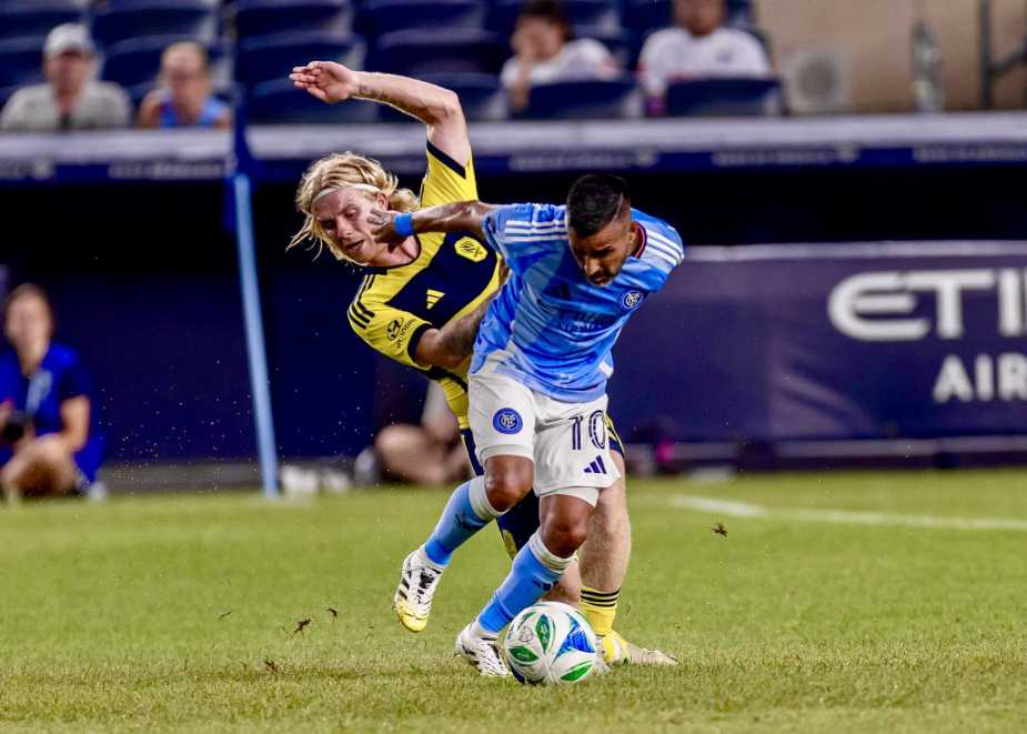 Maxi Moralez number 10 of New York City FC dribbles ball while being challenged by Edvard Tagseth number 20 of Nashville SC