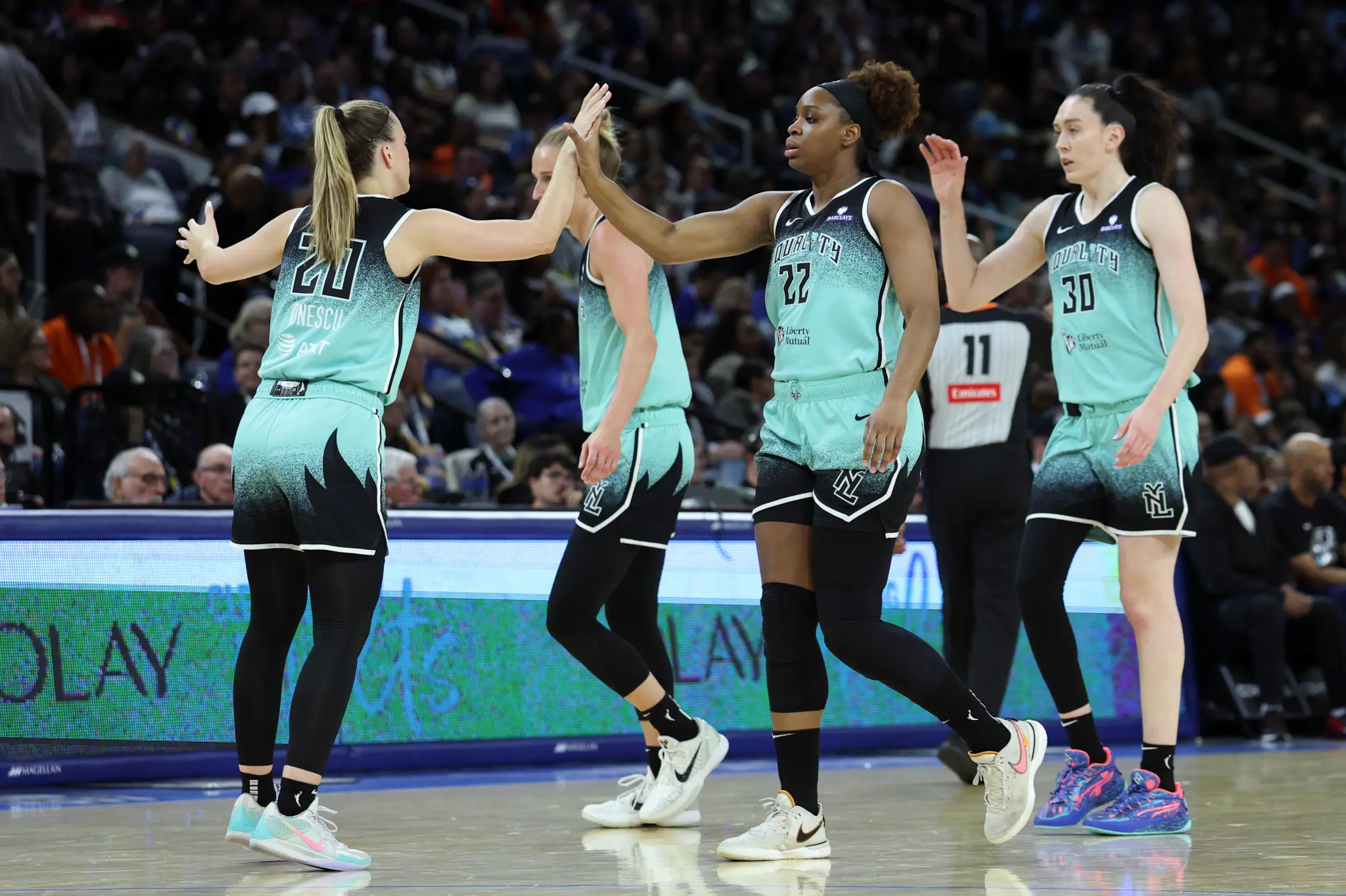 New York Liberty players celebrating after scoring on the sky after a timeout was called by Chicago Sky.