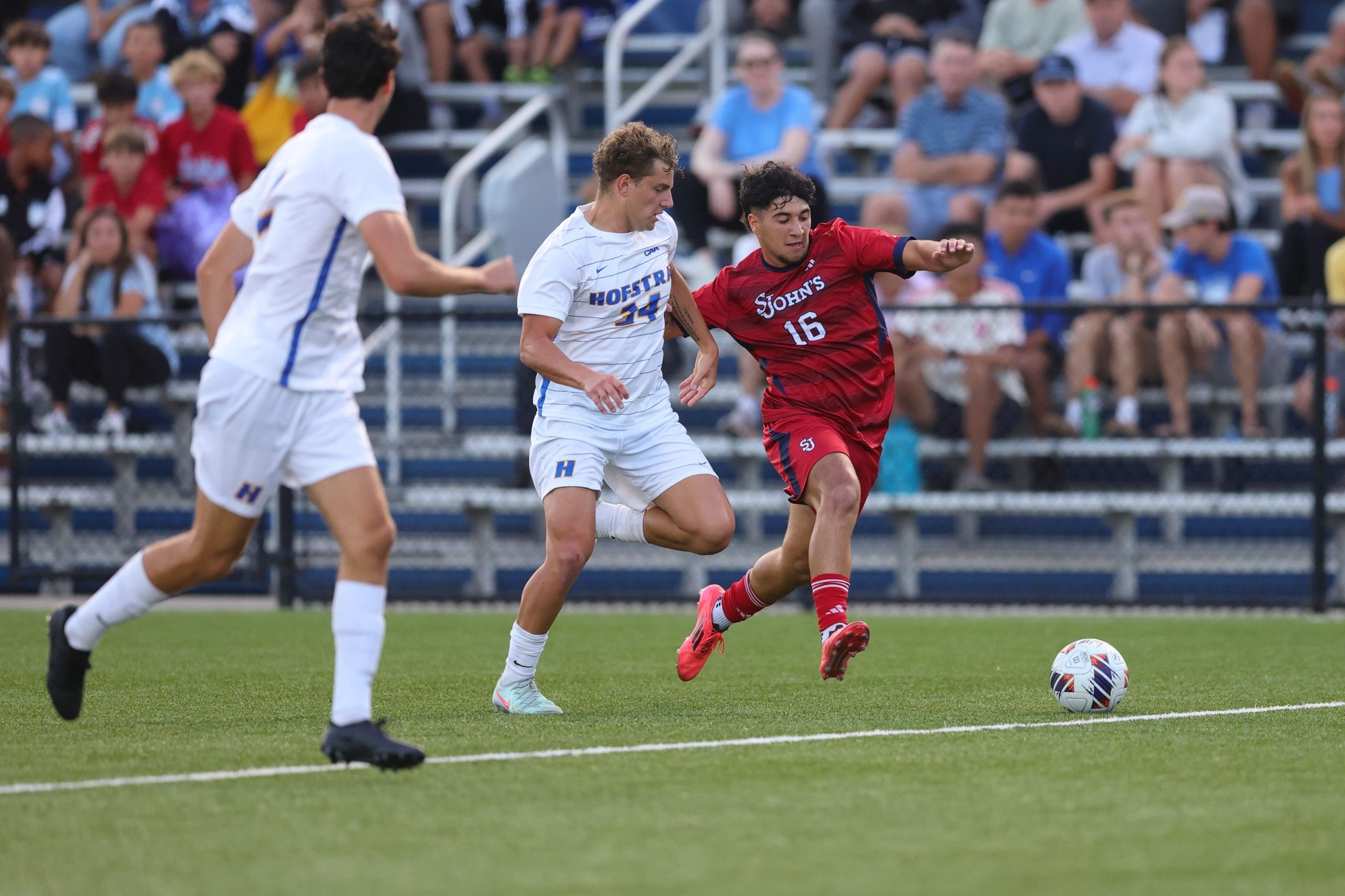 Hofstra midfielder Aleksei Armas (#34) battles St. John's forward Luca Fargnoli (#16) for possession during 2-0 victory at Captains Field