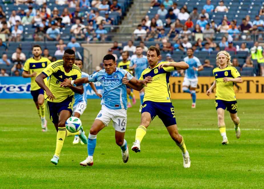 Alonso Martinez number 16 of New York City FC dribbles between Jack Maher number 5 and Jeisson Palacios number 4 of Nashville SC