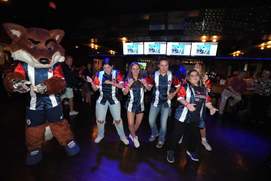 Sly dancing with a group of participants in the event. 