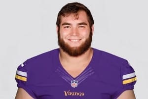 Headshot of Zack Bailey, an offensive lineman for the Minnesota Vikings, wearing a purple jersey with a smiling expression.