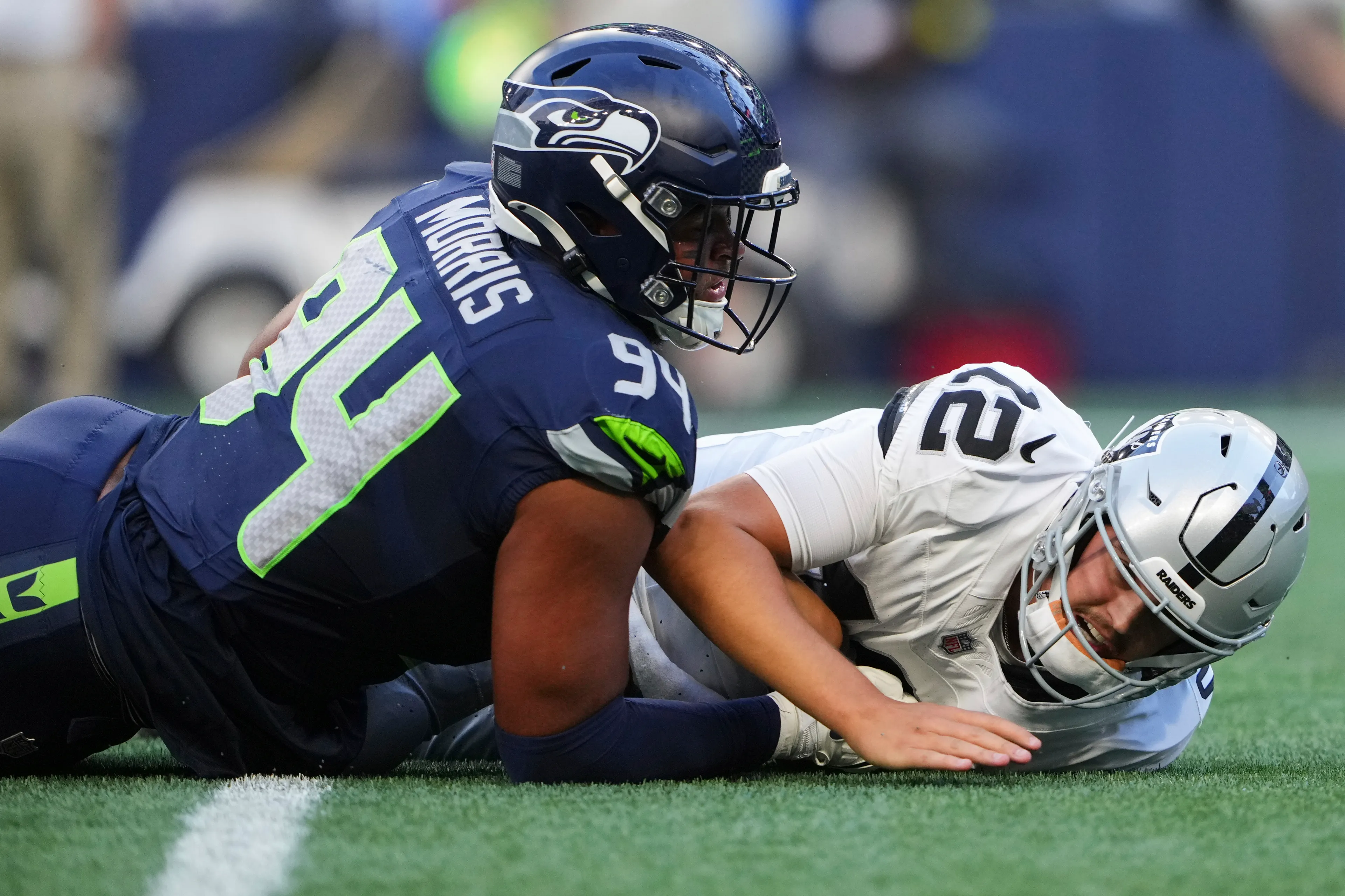 Seattle Seahawks defensive end Mike Morris (94) forces an imcomplete pass by Las Vegas Raiders quarterback Aiden O'Connell (12) during the first half of the NFL preseason week 1 matchup on Thursday, August 7, 2025in Seattle.(AP Photo/Lindsey Wasson).