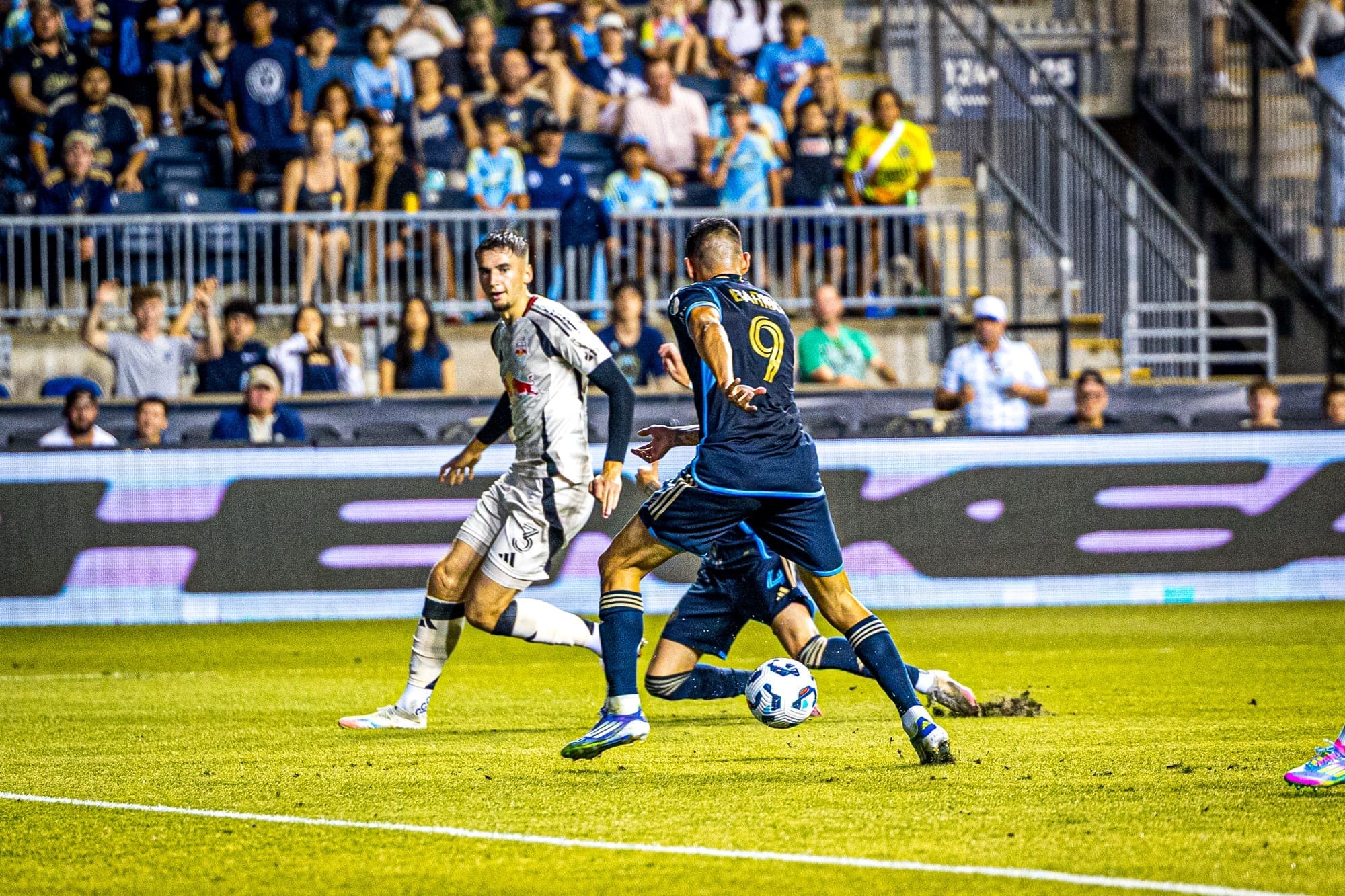 Philadelphia Union player Tai Baribo (#9) dribbles past New York Red Bulls defender during MLS Eastern Conference match at Subaru Park