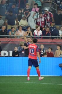 Carles Gil celebrates in New England Revolution red jersey after breaking club goal contributions record against D.C. United