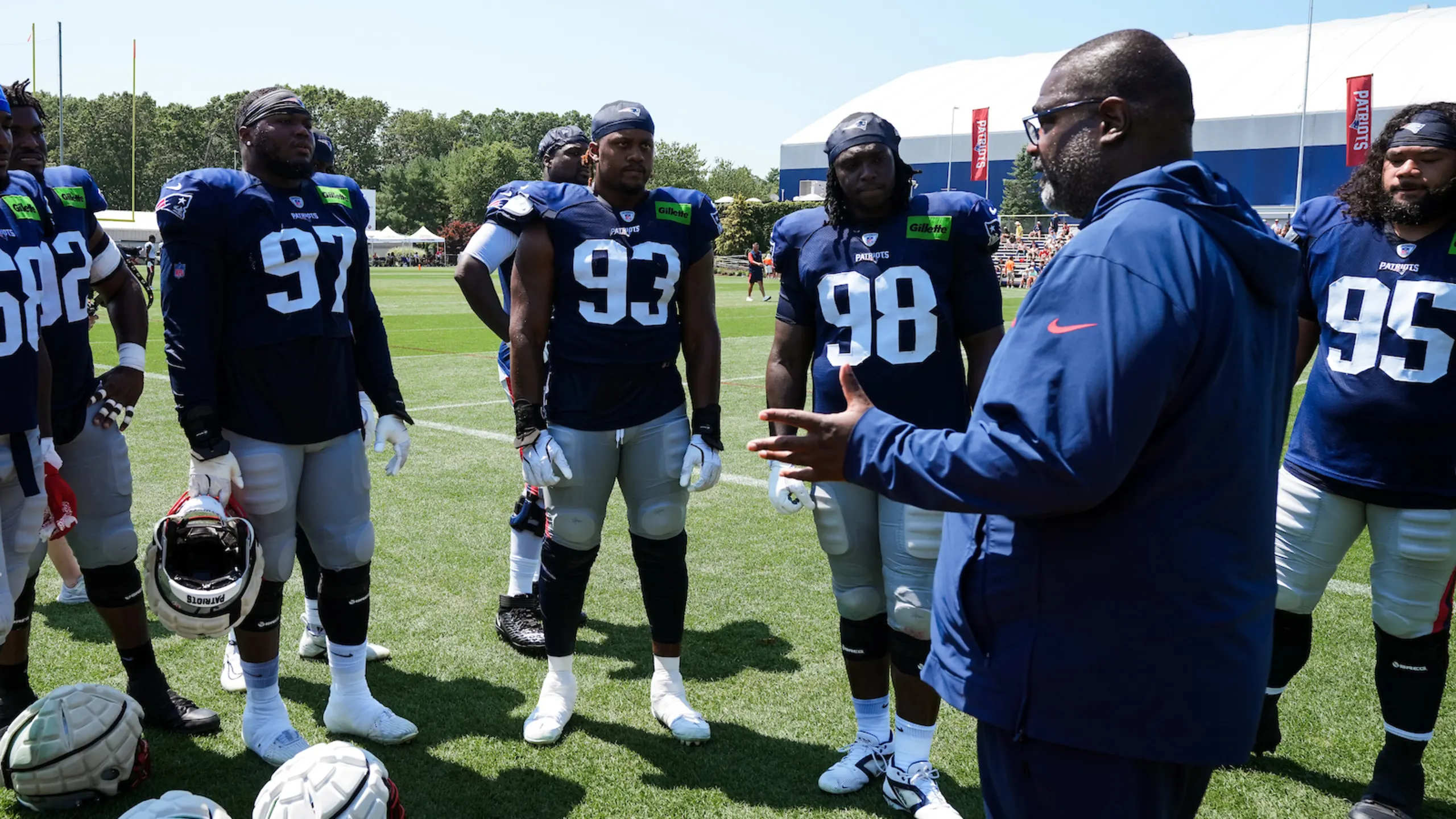 Patriots defensive coordinator Terrell Williams instructs defensive line players during training camp practice session