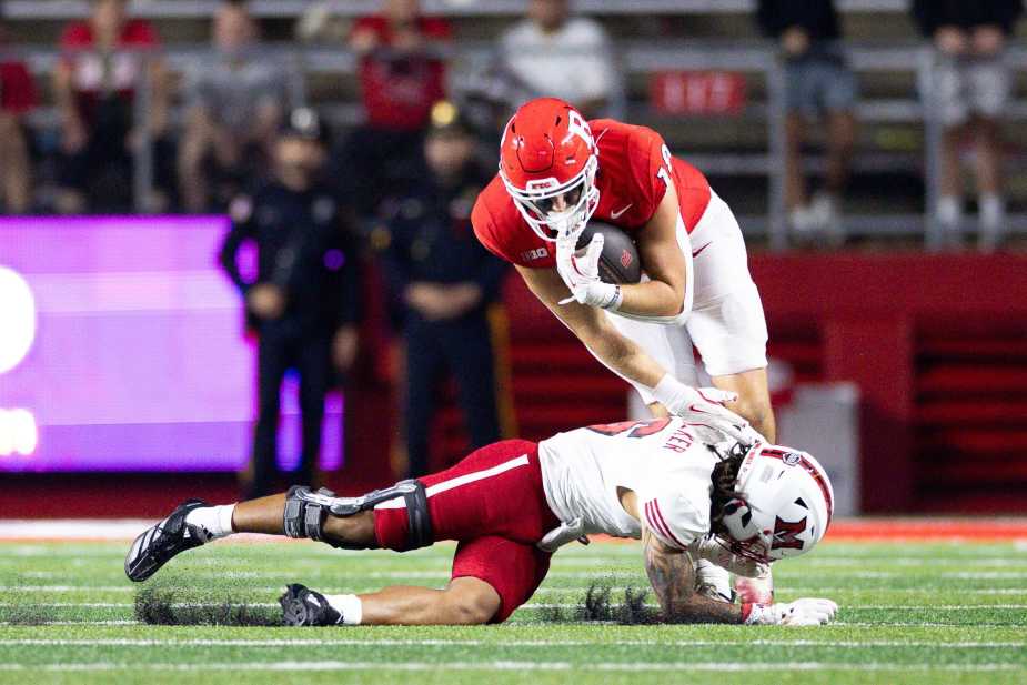 Rutgers tight end (#18) attempts to hurdle over Miami (Ohio) defensive back Adrian Walker Jr. who dives low for the tackle
