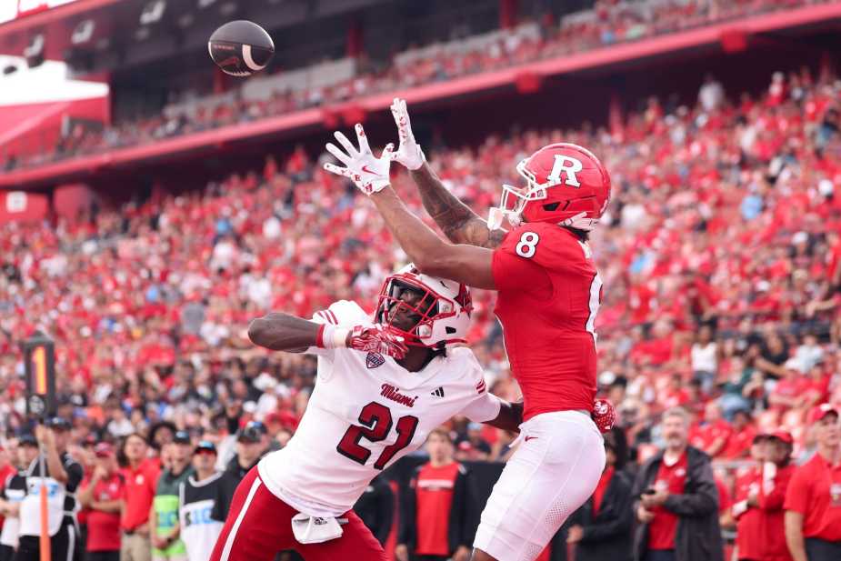 Rutgers wide receiver KJ Duff(#8) leaps to catch a football over a Miami (Ohio) defensive back (#21) Toney Coleman Jr. in white jersey