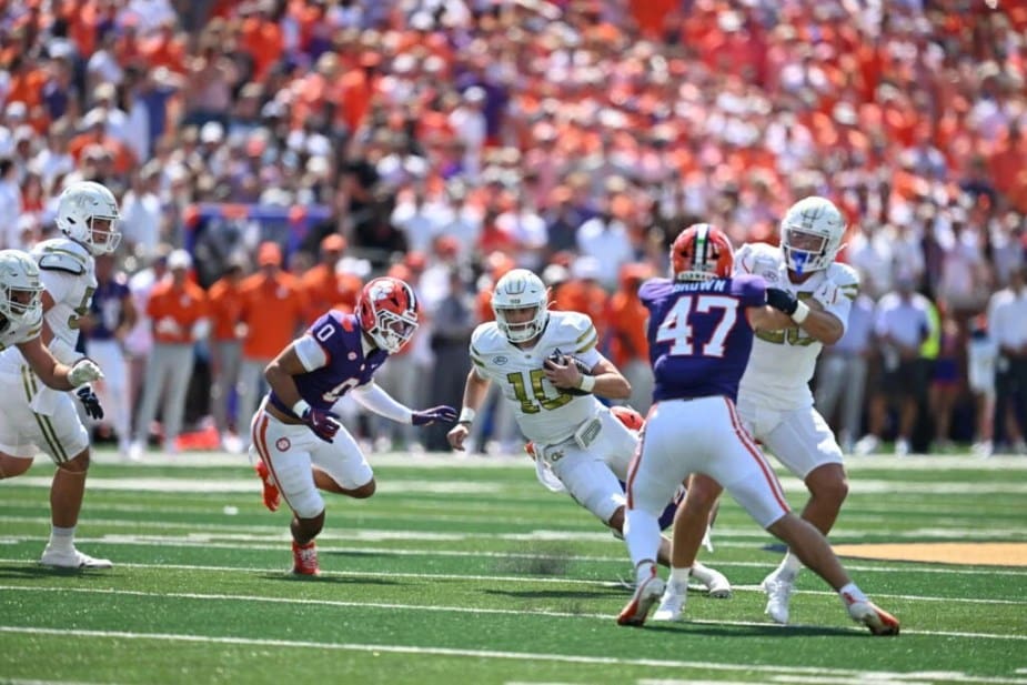 Georgia Tech quarterback Haynes King (#10) scrambles for a significant gain, breaking through a defensive gap during the upset victory over #!2 Clemson
