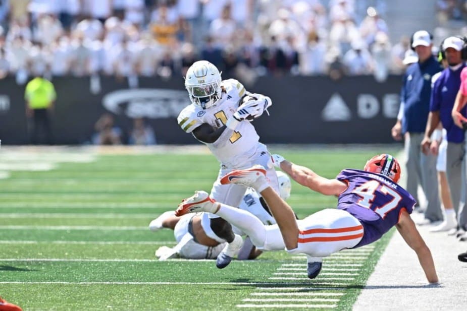 Georgia Tech running back Jamal Haynes breaks through a tackle attempt and accelerates down the sideline for a significant gain against Clemson
