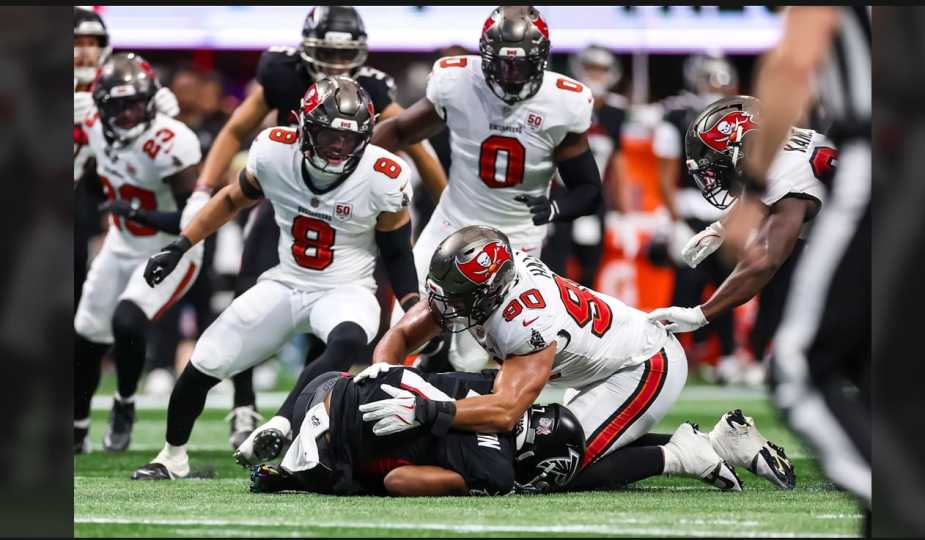Tampa Bay Buccaneers defensive end Logan Hall (#90) sacks Atlanta Falcons quarterback Michael Penix Jr. during NFL game at Mercedes-Benz Stadium