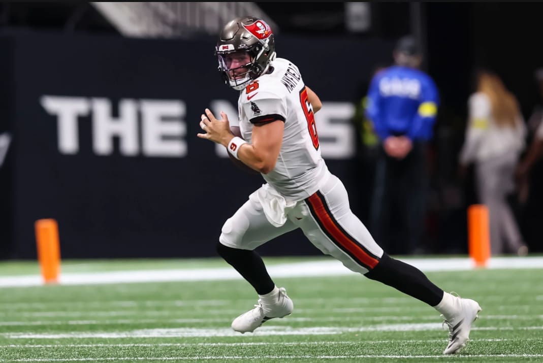 Tampa Bay Buccaneers quarterback Baker Mayfield scrambles with the football during NFL game action