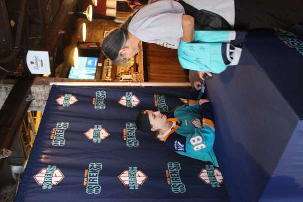 New York Sirens draft pick signing autograph for an older female fan