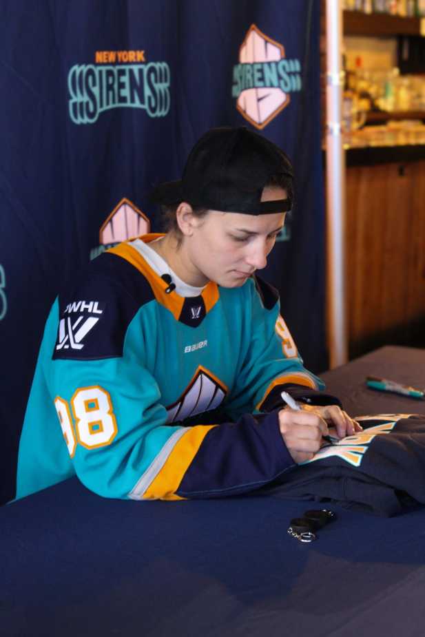 New York Sirens draft pick signing autograph at fan meet and greet event