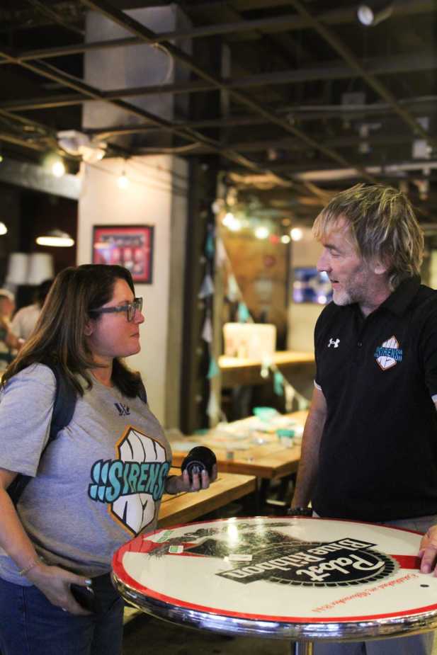 New York Sirens General Manager Pascal Daoust speaking with female fan wearing Sirens t-shirt at meet and greet