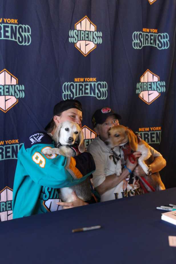 New York Sirens first overall draft pick Kristyna Kaltounkova and fan holding puppies during meet and greet event
