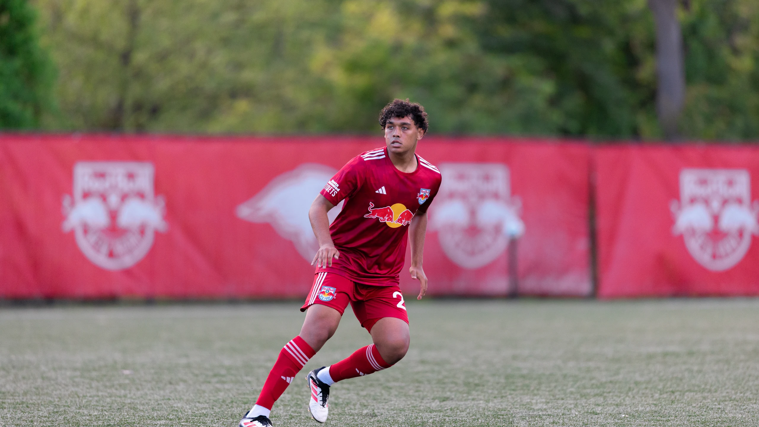 Davi Alexandre in New York Red Bulls training gear, standing on the training field, looking reflective during his final moments with the club