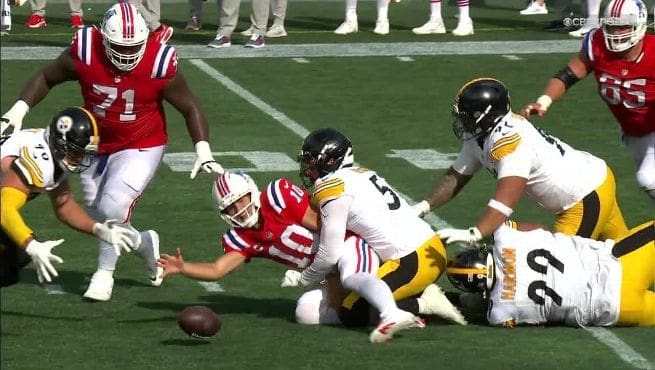 New England Patriots quarterback Drake Maye #10 losing control of football while being tackled by Pittsburgh Steelers defenders during 21-14 loss at Gillette Stadium