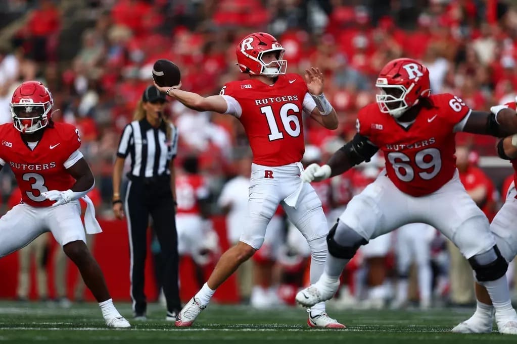 Rutgers quarterback Athan Kaliakmanis (#16) drops back and prepares to throw a pass while protected by his offensive line, including #69, during the Scarlet Knights' 60-10 victory over Norfolk State