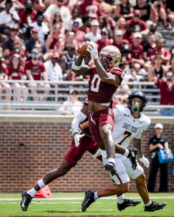 FSU wide receiver Earl Little Jr. (#0) makes spectacular one-handed catch over East Texas A&M defender during 77-3 victory at Doak Campbell Stadium