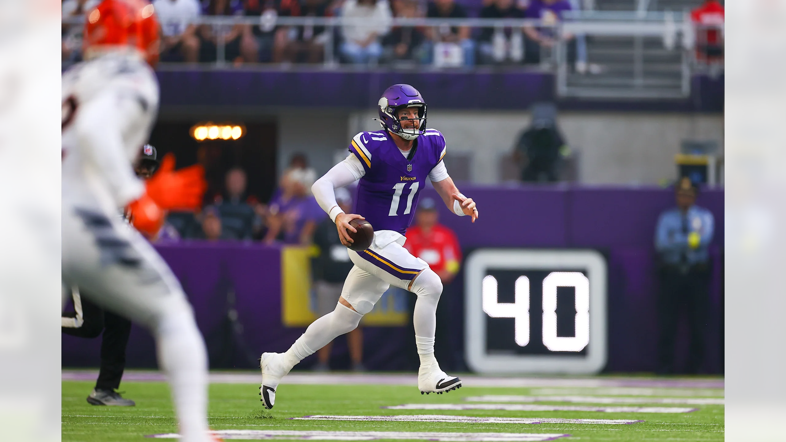 Carson Wentz #11 Minnesota Vikings quarterback scrambles outside the pocket preparing to complete a pass to Justin Jefferson during the Bengals game