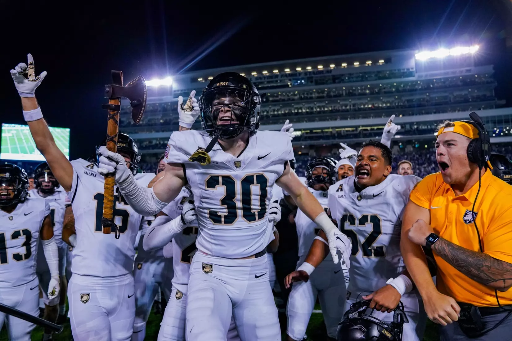 Army West Point football player Collin Matteson celebrates with teammates on the field after their historic 24-21 victory over Kansas State, showing the joy and camaraderie following his game-winning interception