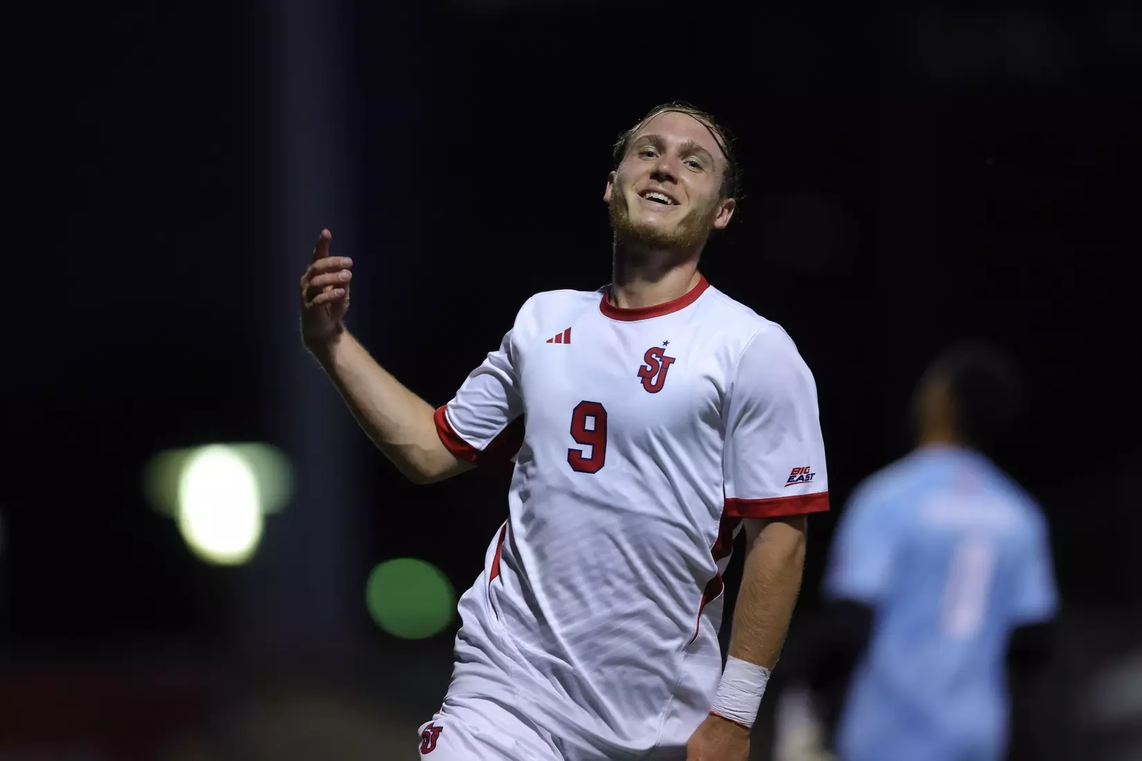 St. John's Men's Soccer forward Gabin Thomelier celebrates his first career goal against Sacred Heart, raising his arms in triumph at Belson Stadium