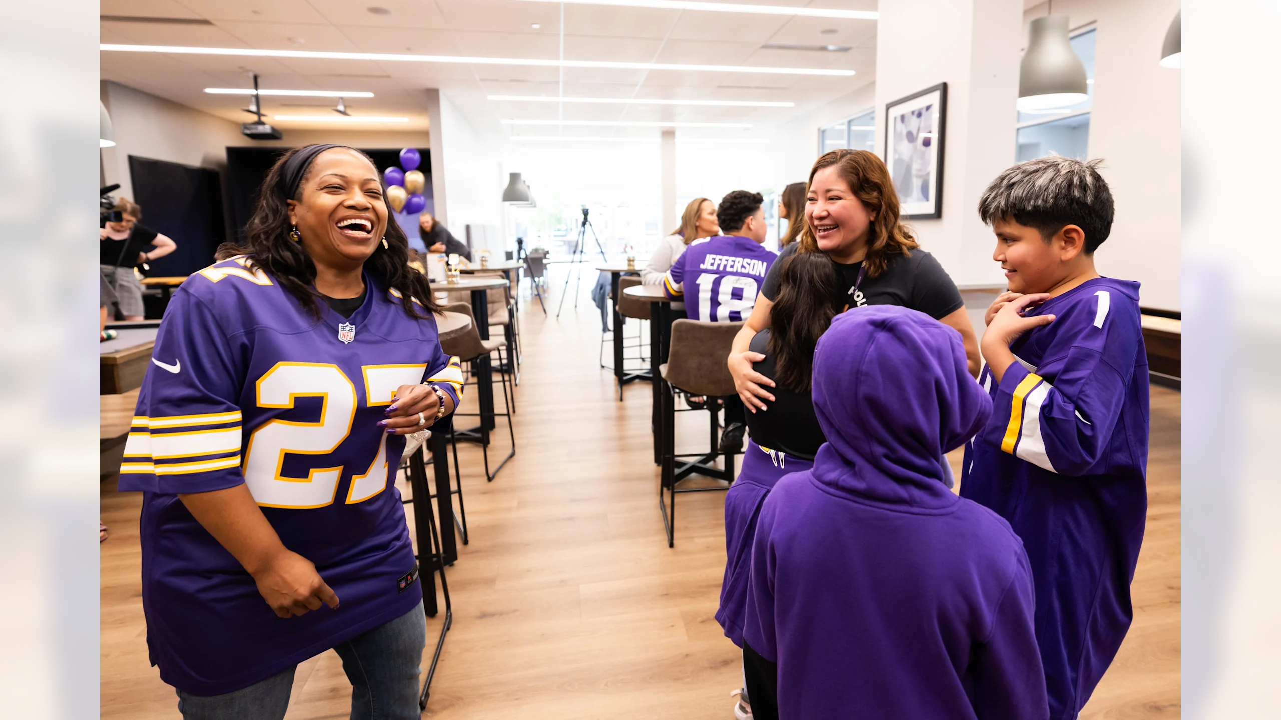 Vikings players' mothers and volunteers shop for back-to-school items at retail store during charitable event for single mothers