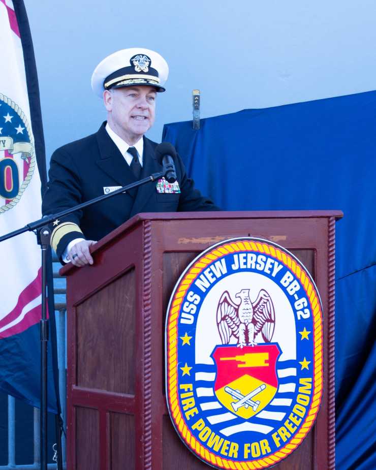 Rear Admiral Ken Blackman, Vice Commander of U.S. Fleet Forces Command, in dress uniform speaks at USS Enterprise stern plate unveiling ceremony during Navy 250th anniversary celebration on October 10, 2025.