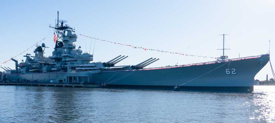Full starboard side view of USS New Jersey (BB-62) with hull number 62 visible, moored in Camden, NJ, during Navy 250th anniversary celebration on October 10, 2025.
