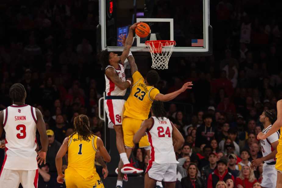 St. John's forward Dillon Mitchell dunks over Michigan Wolverines defender during overtime thriller at Madison Square Garden on October 25, 2025