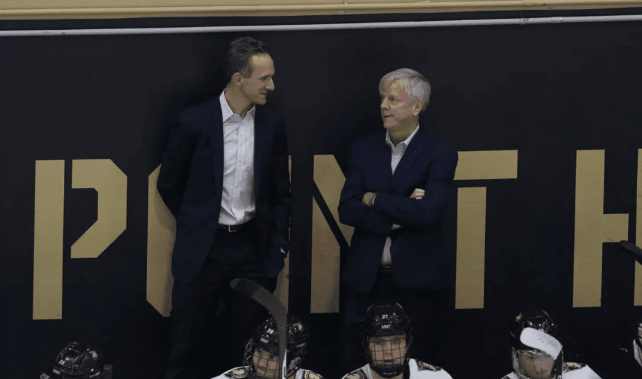 Zach McKelvie talking to old Army coach Brian Riley last season behind the bench