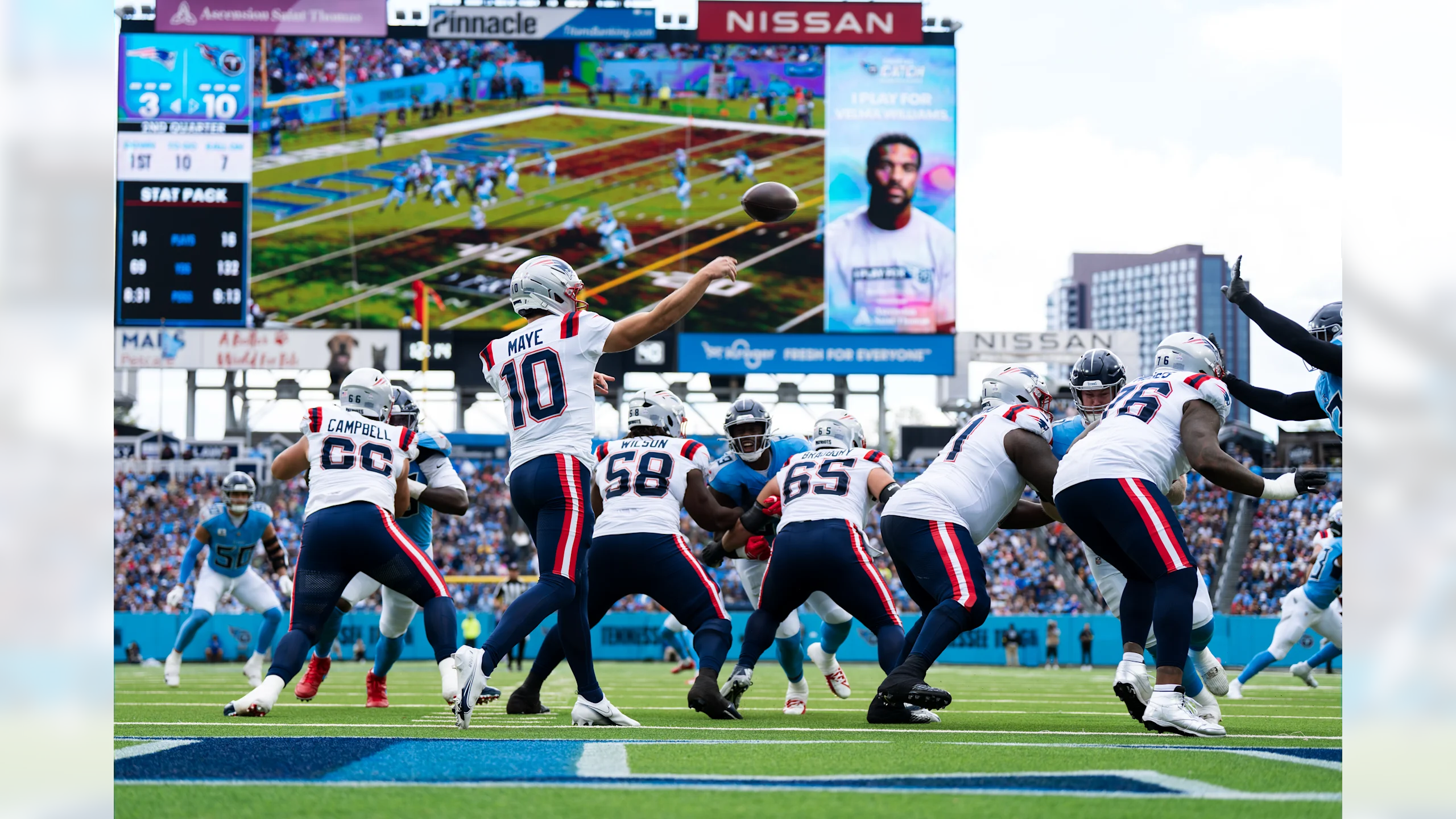 Drake Maye drops back in the pocket and throws a pass against the Tennessee Titans defense at Nissan Stadium in Nashville