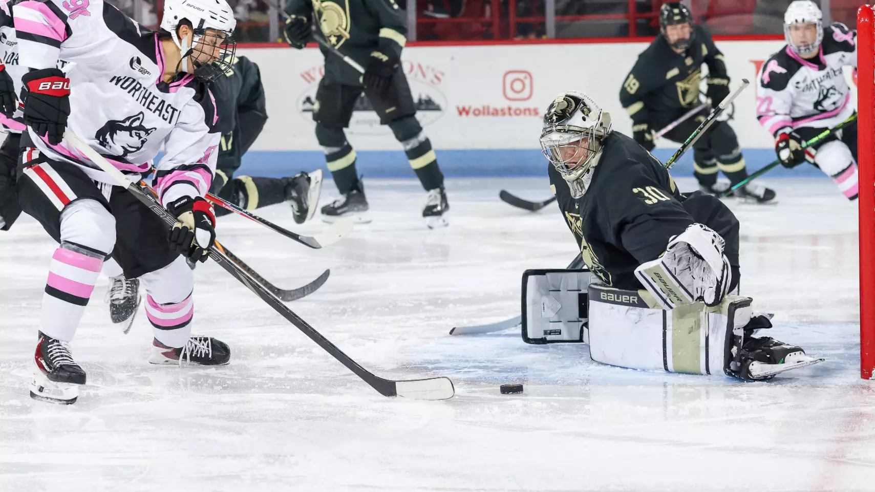Army West Point goaltender JJ Cataldo in full gear making a save during game action, earning Atlantic Hockey America Goaltender of the Week honors after posting .973 save percentage