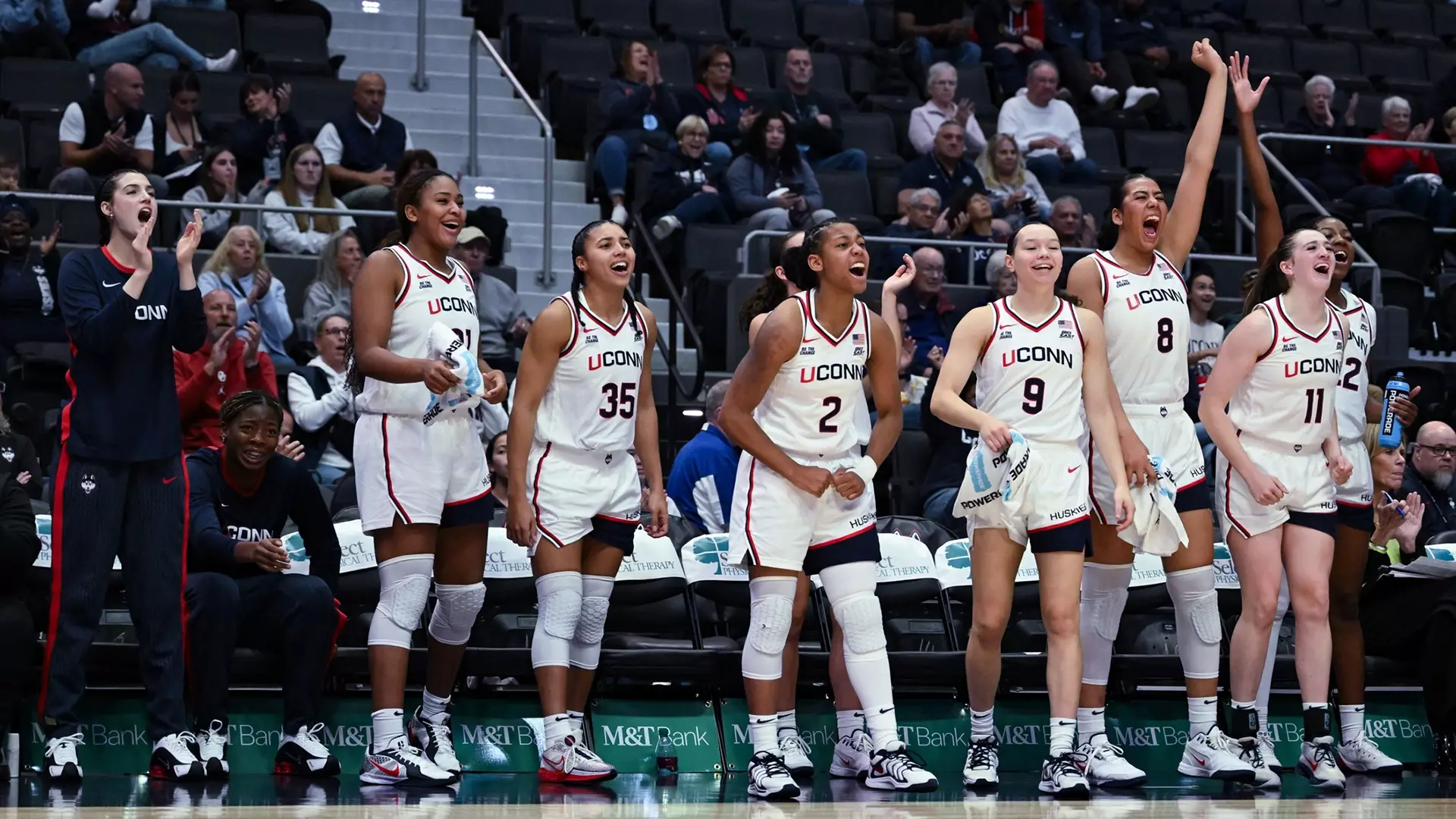 UConn Huskies women's basketball player in white home uniform during game action
