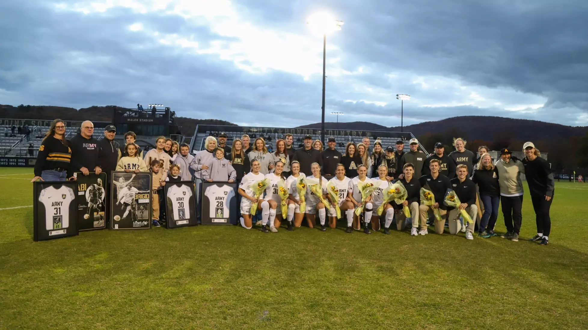 Army West Point women's soccer seniors pose with their families during Senior Night ceremony at Clinton Field on October 24, 2025