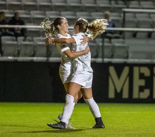 Army West Point's Bella Conti celebrates with goal scorer Brigid Duffy after Duffy's goal against Loyola at Clinton Field on October 24, 2025