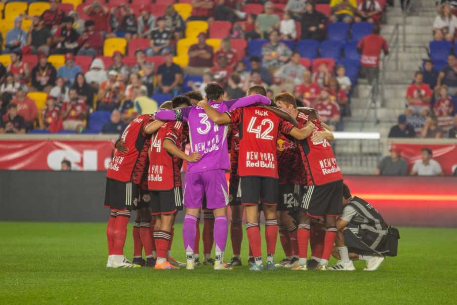 New York Red Bulls starting eleven huddle together in a pre-match team circle led by captain and goalkeeper Carlos Coronel before their match against FC Cincinnati at Sports Illustrated Stadium on October 4, 2025