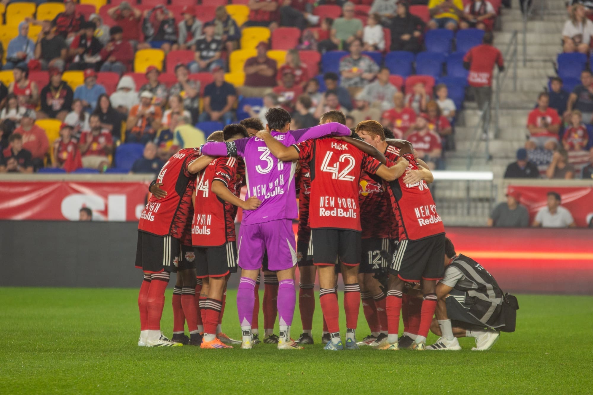 New York Red Bulls starting eleven huddle together in a pre-match team circle led by captain and goalkeeper Carlos Coronel before their match against FC Cincinnati at Sports Illustrated Stadium on October 4, 2025